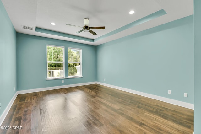 117 Cedar Hammock Ln, Panama City Beach, FL 32407 - empty room featuring a raised ceiling, ceiling fan, wood finished floors, baseboards, and recessed lighting