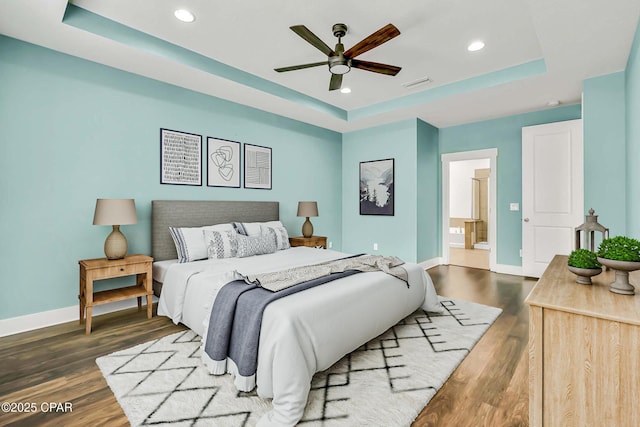 117 Cedar Hammock Ln, Panama City Beach, FL 32407 - bedroom featuring a tray ceiling, baseboards, recessed lighting, and wood finished floors