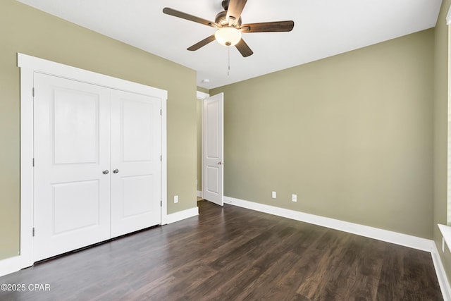 117 Cedar Hammock Ln, Panama City Beach, FL 32407 - unfurnished bedroom with dark wood-style flooring, baseboards, a closet, and a ceiling fan