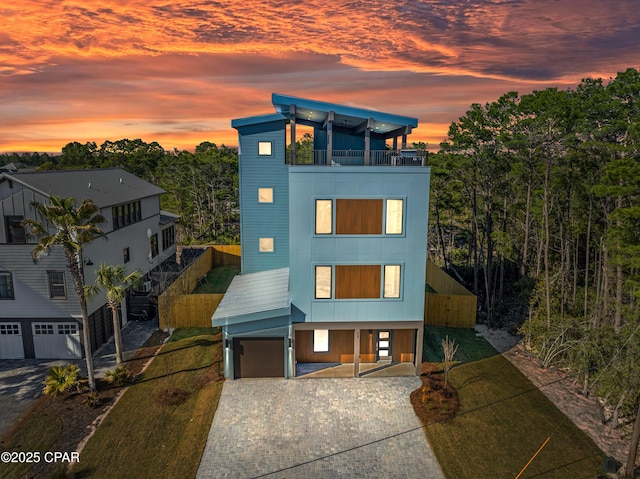 17 Woodland Dr, Santa Rosa Beach, FL 32459 - modern home with a balcony, decorative driveway, a garage, and a front lawn