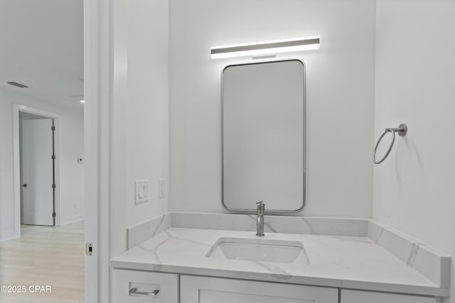 17 Woodland Dr, Santa Rosa Beach, FL 32459 - bathroom featuring visible vents, vanity, and wood finished floors