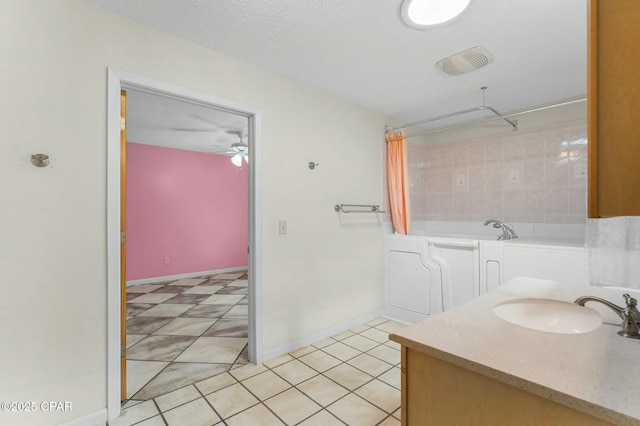 bathroom with visible vents, baseboards, a ceiling fan, a sink, and tile patterned flooring