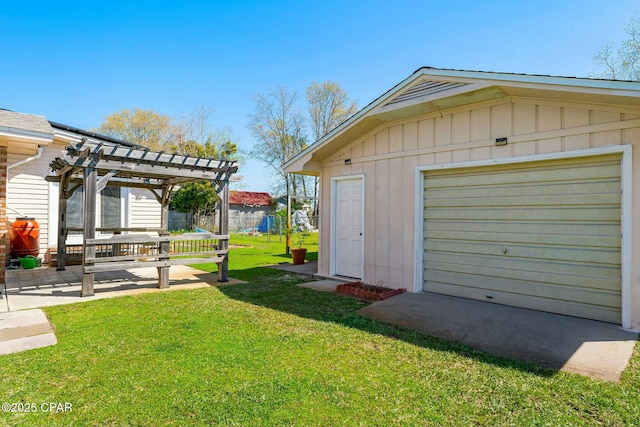 view of yard featuring an outbuilding, fence, a pergola, a patio, and a garage