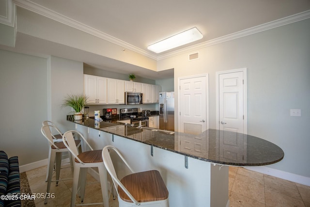 16819 Front Beach Rd Unit 2903, Panama City Beach, FL 32413 - kitchen featuring baseboards, ornamental molding, visible vents, a peninsula, and stainless steel appliances