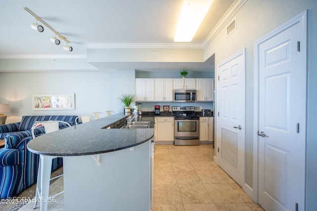 16819 Front Beach Rd Unit 2903, Panama City Beach, FL 32413 - kitchen with a sink, stainless steel appliances, a kitchen breakfast bar, crown molding, and visible vents