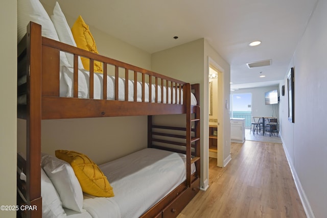 bedroom featuring wood finished floors, baseboards, and recessed lighting