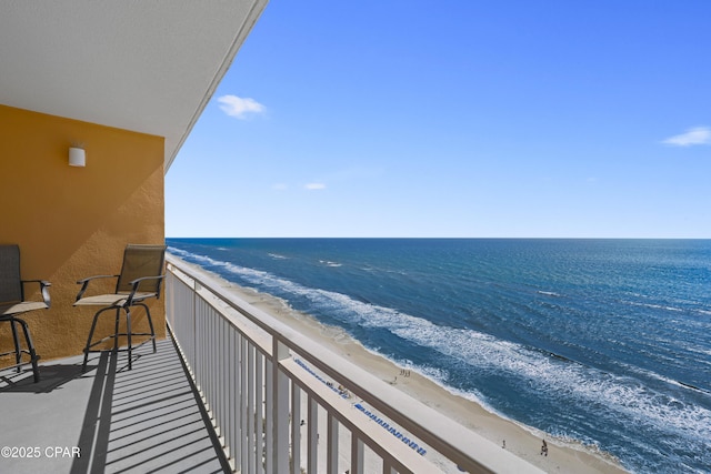 balcony with view of water and beach