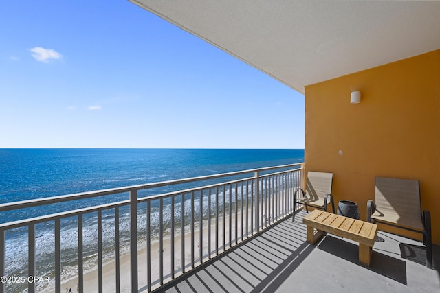 balcony featuring view of water and beach
