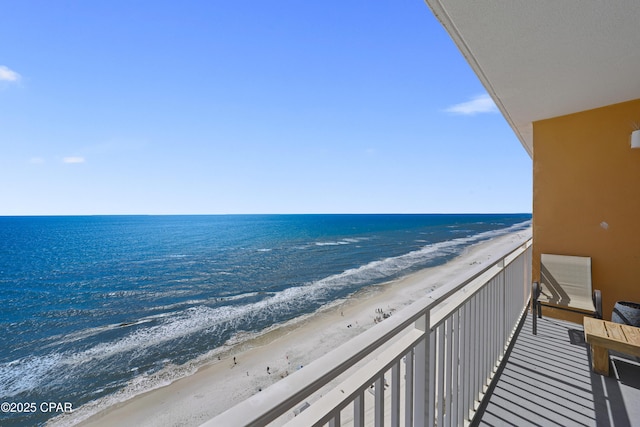 balcony featuring view of water and beach