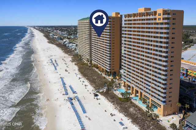 bird's eye view of waterfront with a beach and apartment complex / building