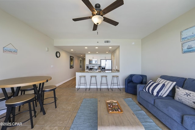living room with ceiling fan, light tile patterned floors, baseboards, and recessed lighting