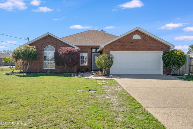 single story home with concrete driveway, a front yard, a shingled roof, a garage, and brick siding
