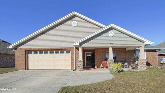 4439 Bylsma Cir, Panama City, FL 32404 - view of front of house featuring driveway, an attached garage, brick siding, covered porch, and a front yard