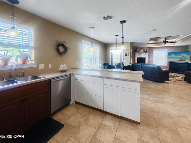 4439 Bylsma Cir, Panama City, FL 32404 - kitchen featuring dishwasher, a sink, plenty of natural light, and a textured ceiling
