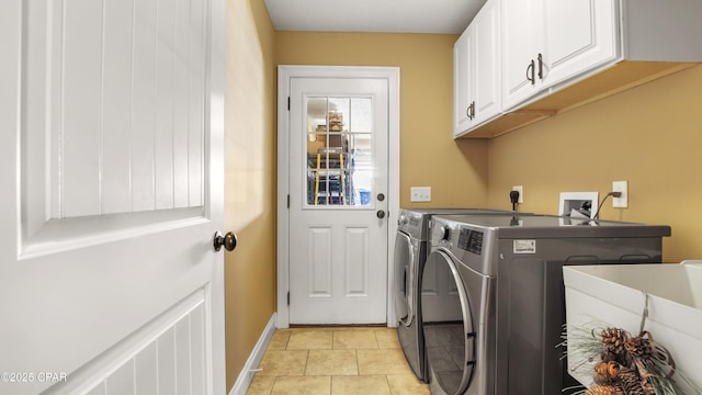 4439 Bylsma Cir, Panama City, FL 32404 - washroom with cabinet space, washing machine and dryer, light tile patterned floors, and baseboards