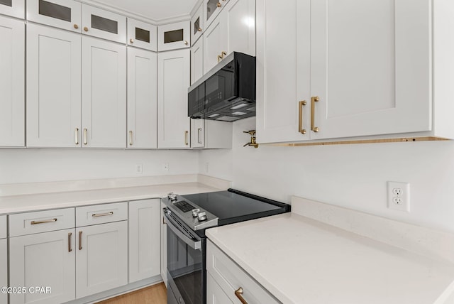 420 Lacosta Ave, Panama City, FL 32404 - kitchen featuring glass insert cabinets, light countertops, appliances with stainless steel finishes, and white cabinets