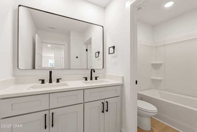 420 Lacosta Ave, Panama City, FL 32404 - full bathroom with double vanity, a sink, toilet, and wood finished floors