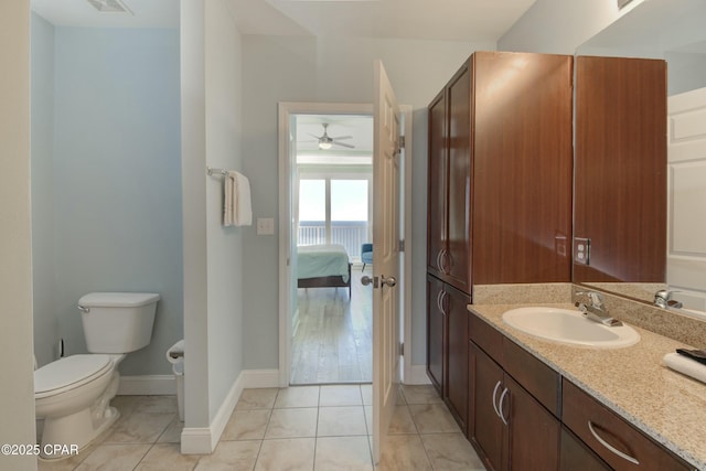 9860 S Thomas Dr Unit 2111, Panama City Beach, FL 32408 - ensuite bathroom featuring vanity, toilet, a ceiling fan, tile patterned floors, and baseboards