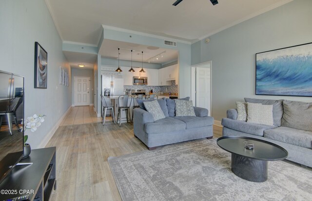 9860 S Thomas Dr Unit 2111, Panama City Beach, FL 32408 - living area with crown molding, light wood-style floors, and baseboards