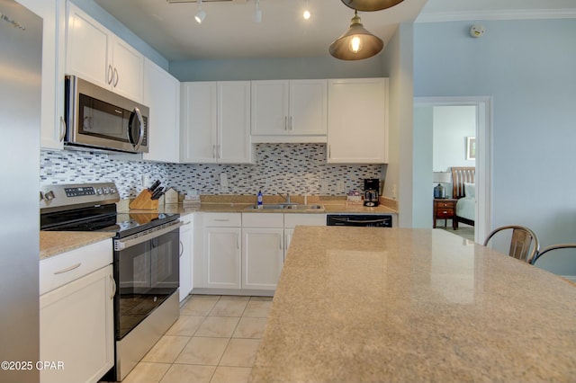 9860 S Thomas Dr Unit 2111, Panama City Beach, FL 32408 - kitchen featuring stainless steel appliances, a sink, decorative backsplash, white cabinetry, and ornamental molding