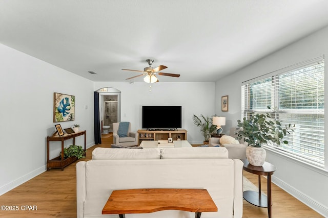 1527 Wateroak Dr, Lynn Haven, FL 32444 - living area with plenty of natural light, a ceiling fan, light wood-style floors, and baseboards
