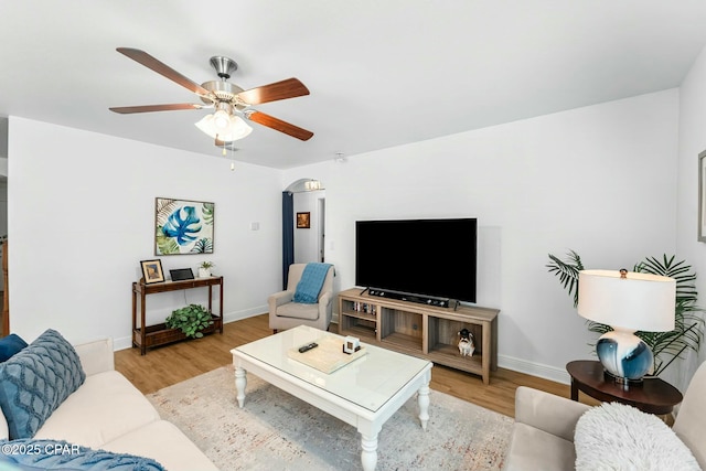 1527 Wateroak Dr, Lynn Haven, FL 32444 - living room with wood finished floors, ceiling fan, baseboards, and arched walkways