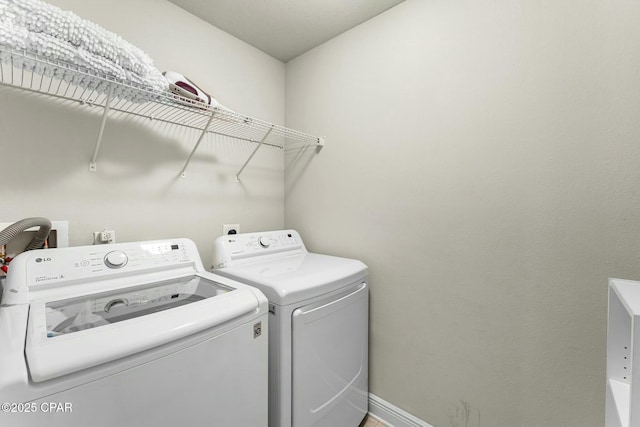 1527 Wateroak Dr, Lynn Haven, FL 32444 - washroom with washing machine and clothes dryer and baseboards