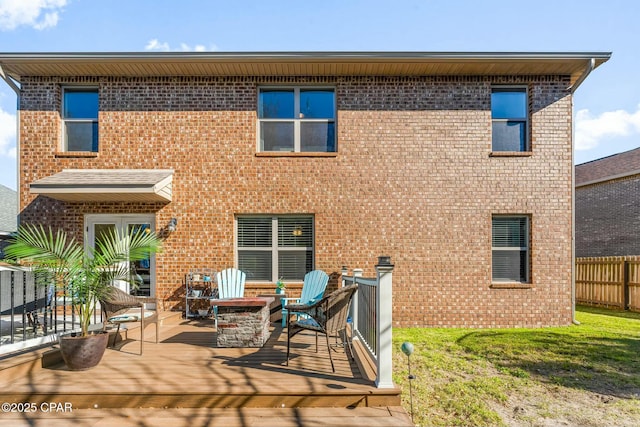 1527 Wateroak Dr, Lynn Haven, FL 32444 - back of property with a deck, a fire pit, and brick siding