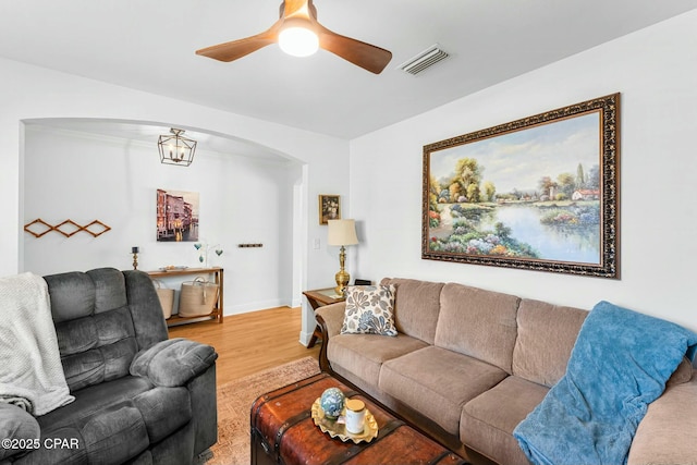 1527 Wateroak Dr, Lynn Haven, FL 32444 - living area featuring arched walkways, light wood finished floors, a ceiling fan, ornamental molding, and baseboards