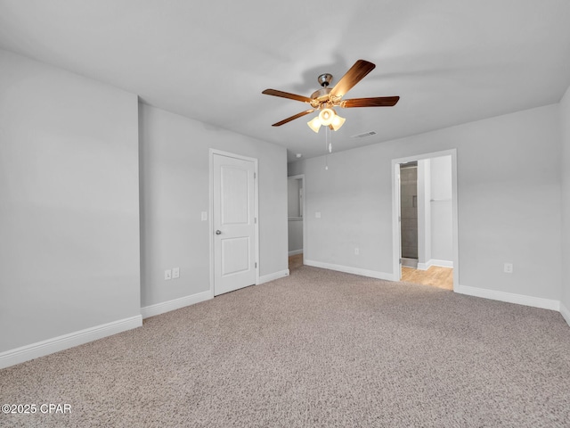 unfurnished bedroom featuring visible vents, baseboards, light colored carpet, and ceiling fan