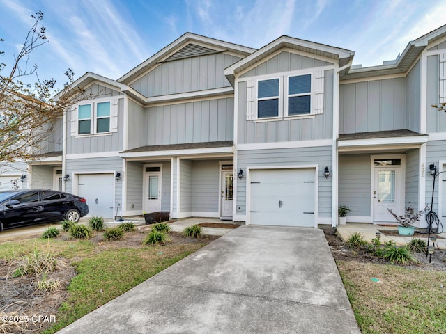 townhome / multi-family property featuring board and batten siding, an attached garage, and concrete driveway
