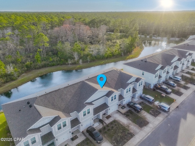 bird's eye view with a wooded view and a water view