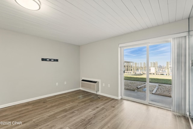 5505 Sun Harbor Rd Unit 143, Panama City, FL 32401 - empty room with baseboards, a city view, wood finished floors, and a wall unit AC