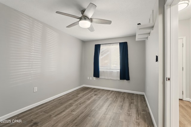 5505 Sun Harbor Rd Unit 143, Panama City, FL 32401 - spare room featuring baseboards, a ceiling fan, wood finished floors, and a textured ceiling
