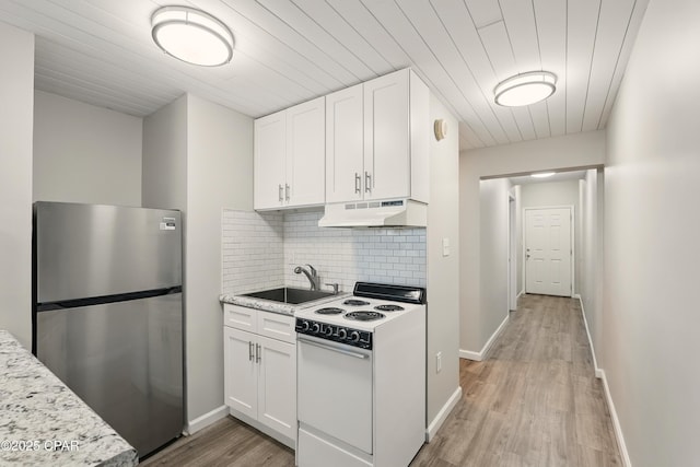 5505 Sun Harbor Rd Unit 143, Panama City, FL 32401 - kitchen featuring under cabinet range hood, a sink, freestanding refrigerator, electric range, and white cabinetry