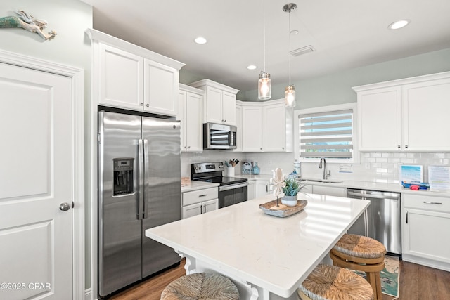 2501 Highway 98 C C, Mexico Beach, FL 32456 - kitchen with stainless steel appliances, a sink, a kitchen bar, white cabinets, and recessed lighting