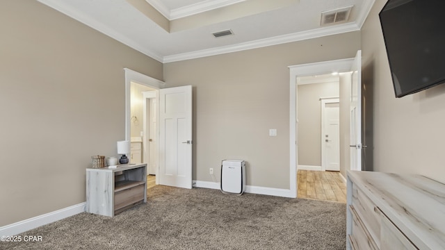 5301 Alexander Ln, Panama City, FL 32404 - bedroom with light carpet, visible vents, ornamental molding, and a tray ceiling