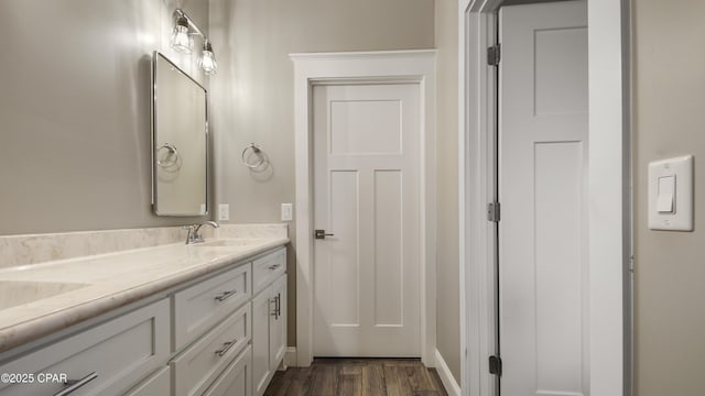 5301 Alexander Ln, Panama City, FL 32404 - bathroom featuring baseboards, wood finished floors, a sink, and double vanity