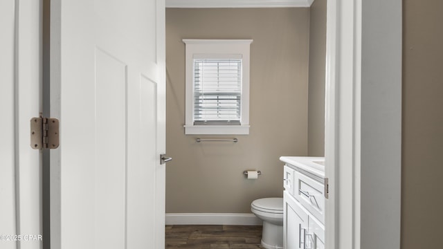 5301 Alexander Ln, Panama City, FL 32404 - bathroom featuring baseboards, toilet, vanity, and wood finished floors