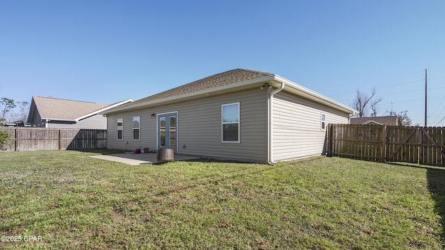 5301 Alexander Ln, Panama City, FL 32404 - rear view of property featuring a yard, a patio, and a fenced backyard