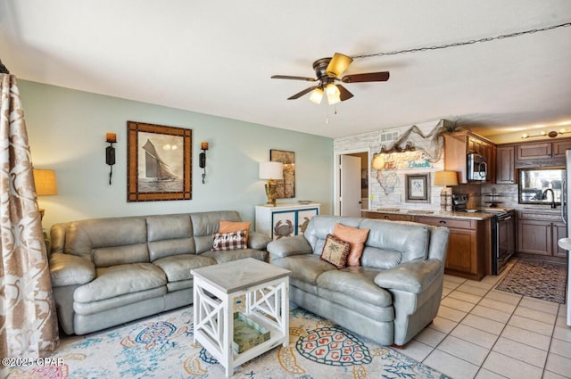 8743 Thomas Dr Unit 225, Panama City Beach, FL 32408 - living room featuring a ceiling fan and light tile patterned floors