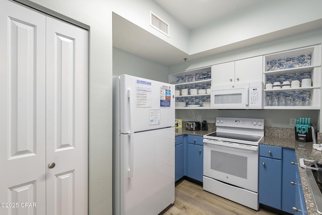 9900 S Thomas Dr Unit 425, Panama City, FL 32408 - kitchen featuring visible vents, blue cabinets, open shelves, and white appliances