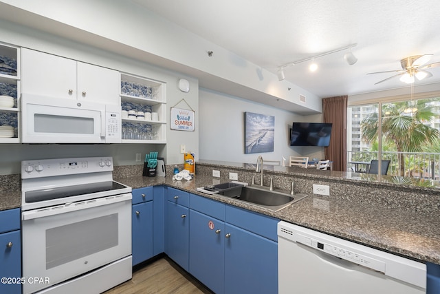 9900 S Thomas Dr Unit 425, Panama City, FL 32408 - kitchen featuring blue cabinetry, a sink, open shelves, and white appliances