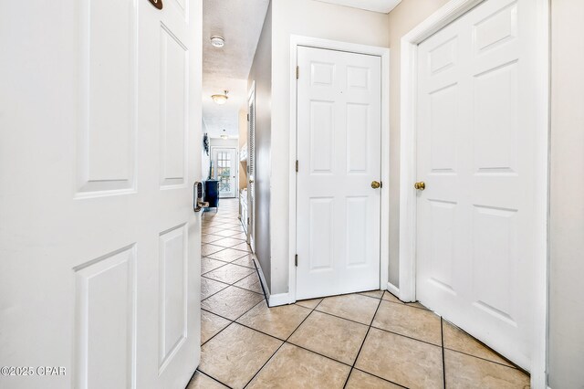 17462 Front Beach Rd Unit 56206, Panama City Beach, FL 32413 - hallway featuring light tile patterned flooring and baseboards