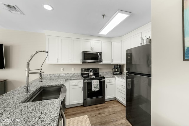 17690 Front Beach Rd Unit D307, Panama City Beach, FL 32413 - kitchen with a sink, visible vents, appliances with stainless steel finishes, and white cabinets