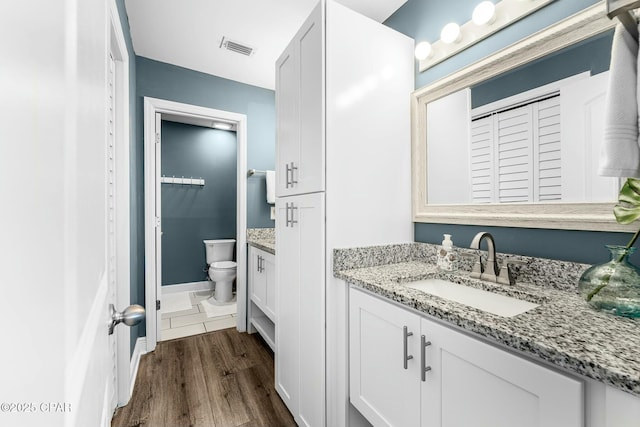 17690 Front Beach Rd Unit D307, Panama City Beach, FL 32413 - bathroom featuring visible vents, toilet, wood finished floors, a closet, and vanity