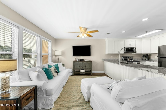 17690 Front Beach Rd Unit D307, Panama City Beach, FL 32413 - living area with visible vents, baseboards, recessed lighting, light wood-style flooring, and a ceiling fan