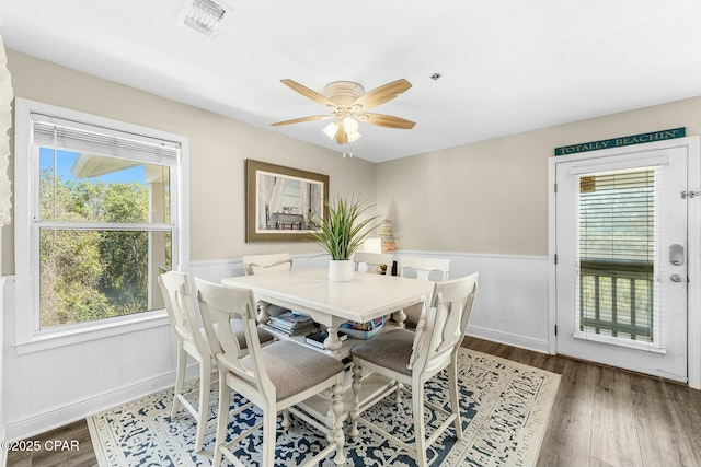 17690 Front Beach Rd Unit D307, Panama City Beach, FL 32413 - dining area with a wainscoted wall, visible vents, wood finished floors, baseboards, and ceiling fan