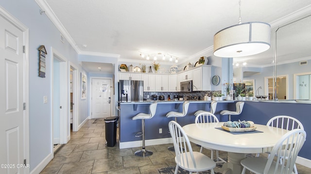 10519 Front Beach Rd Unit 1904B, Panama City Beach, FL 32407 - dining space featuring visible vents, baseboards, and ornamental molding
