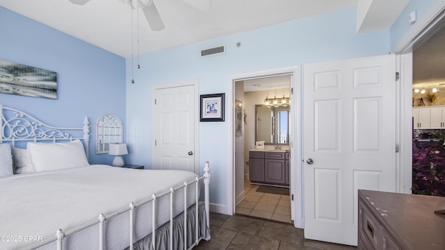 10519 Front Beach Rd Unit 1904B, Panama City Beach, FL 32407 - bedroom featuring visible vents, a sink, dark tile patterned floors, ceiling fan, and ensuite bathroom